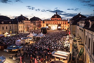 German roc band Revolverheld playing on a stage (center) in the palace courtyard, August 2016.